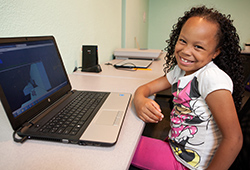 Girl on laptop in education center